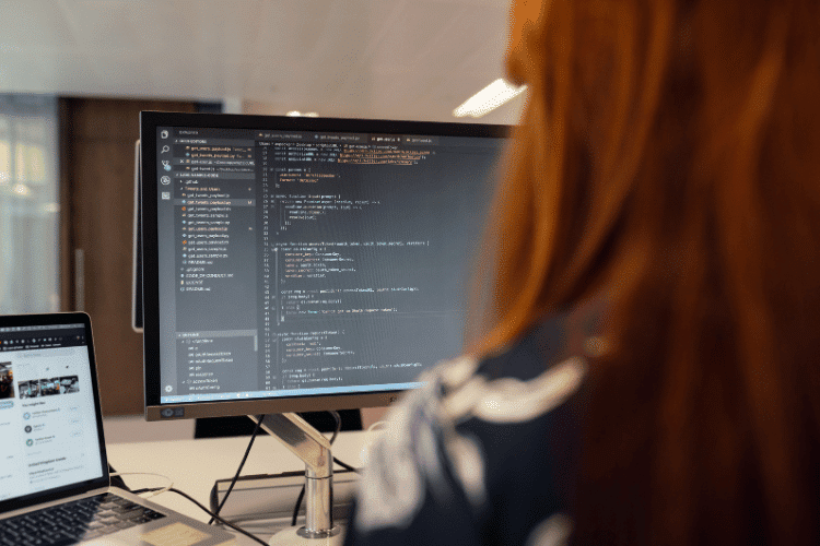 Close-up of a female software engineer working on a desktop computer