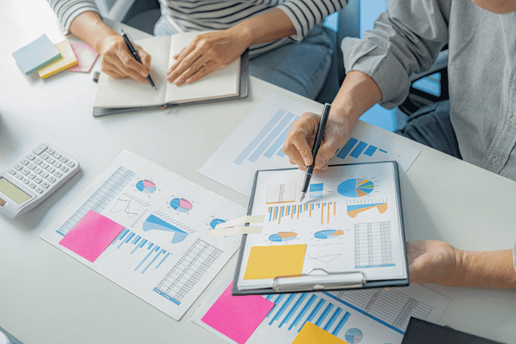 Close-up of an accredited investment mentor guiding one of his team