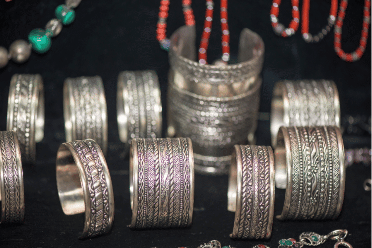 Close-up of silver jewelers with black background