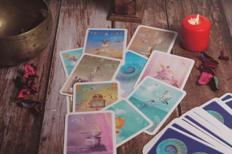 Set of Magic Cards on a wooden table with a red candle